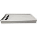 Wall to wall closeout shower pan, grey skim coated surface, angled view showing the curb